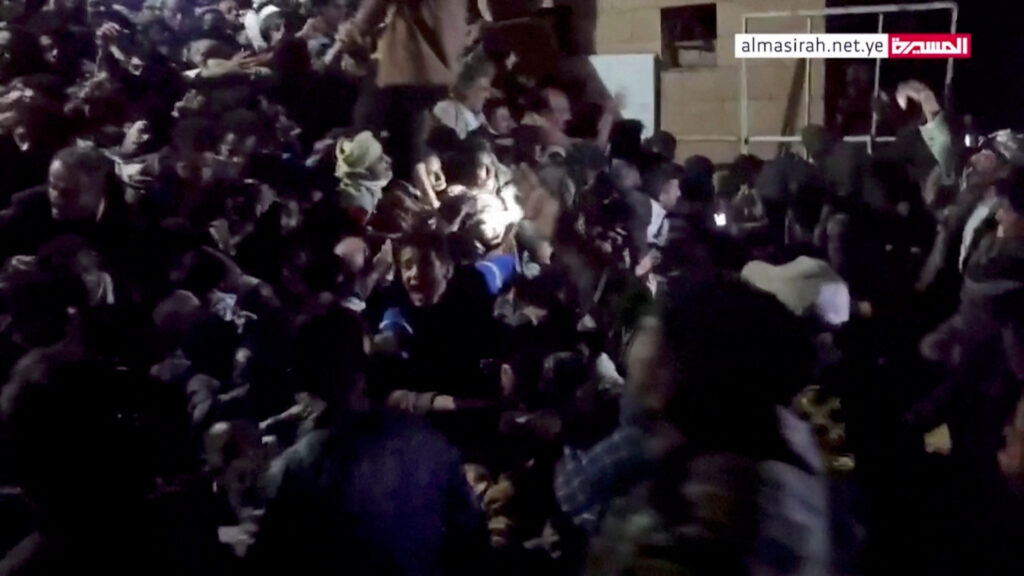 People trapped in the crowd attempt to free themselves during a stampede in Sanaa, Yemen, April 19, 2023, in this still image taken from video. Al Masirah TV/via Reuters TV/Handout via REUTERS