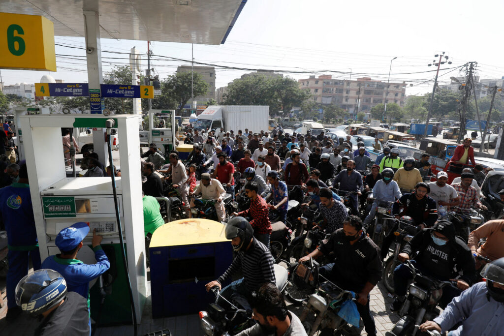 People on motorcycles wait for their turn to get petrol at a petrol station in Karachi, Pakistan. REUTERS/Akhtar Soomro