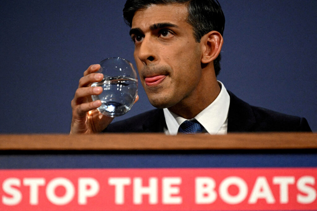 British Prime Minister Rishi Sunak drinks water during a press conference following the launch of new legislation on migrant channel crossings at Downing Street in London, United Kingdom. Leon Neal/Pool via REUTERS