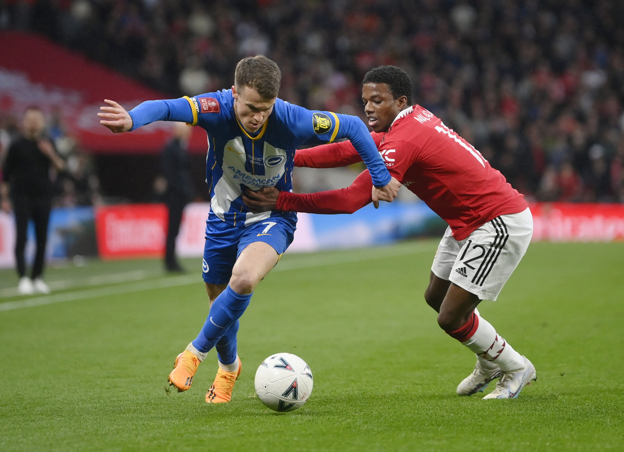 Brighton & Hove Albion's Solly March in action with Manchester United's Tyrell Malacia REUTERS/Toby Melville