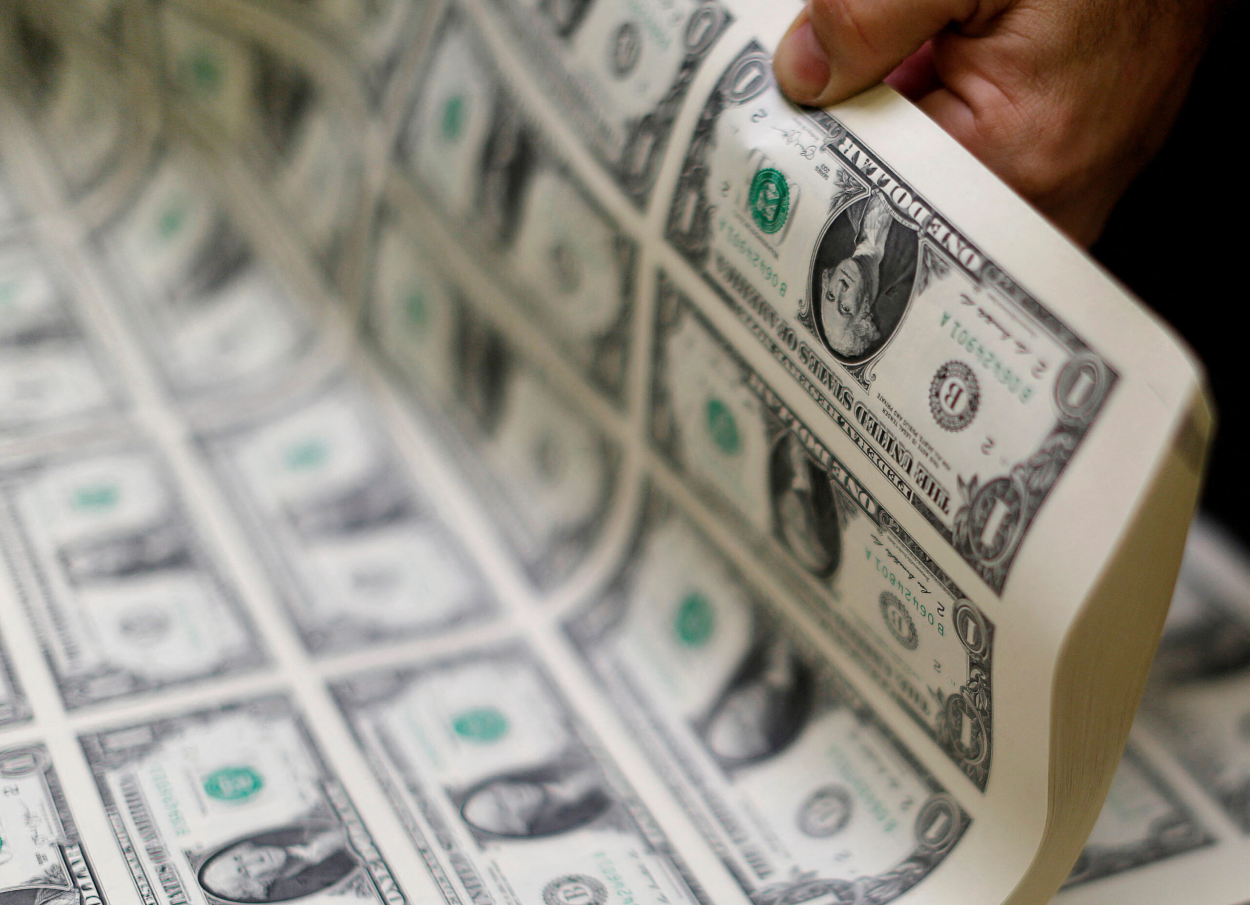 FILE PHOTO: United States one dollar bills are curled and inspected during production at the Bureau of Engraving and Printing in Washington. REUTERS/Gary Cameron