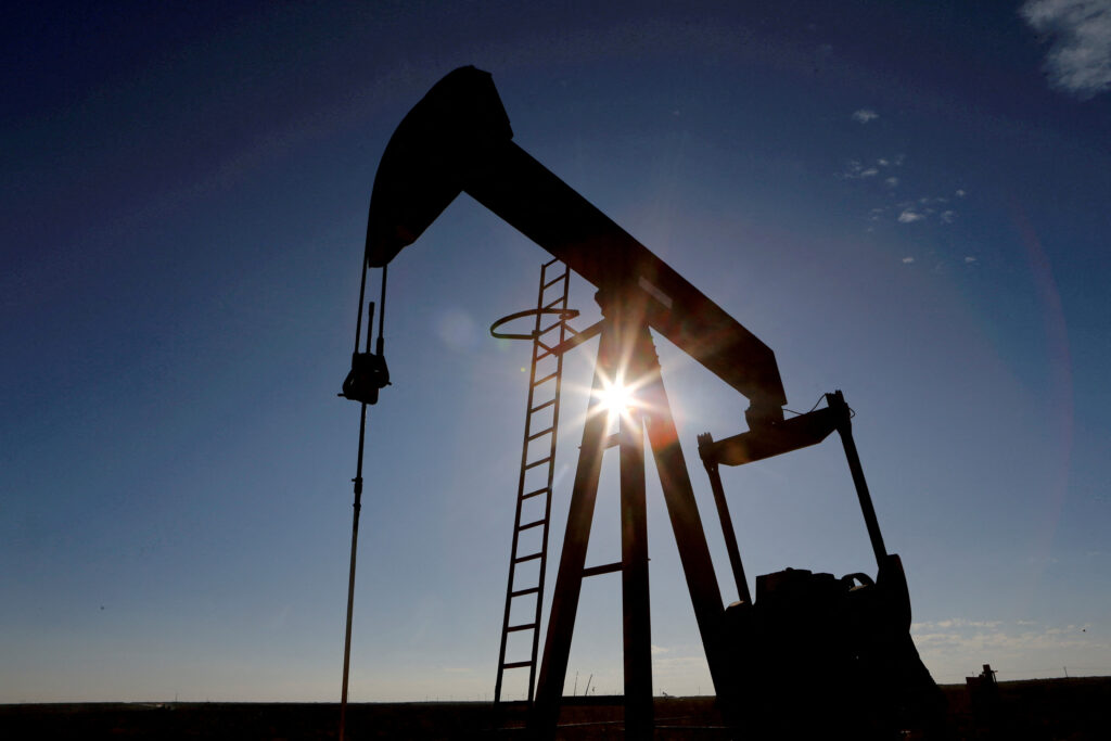 The sun is seen behind a crude oil pump jack in the Permian Basin in Loving County, Texas, U.S. REUTERS/Angus Mordant/