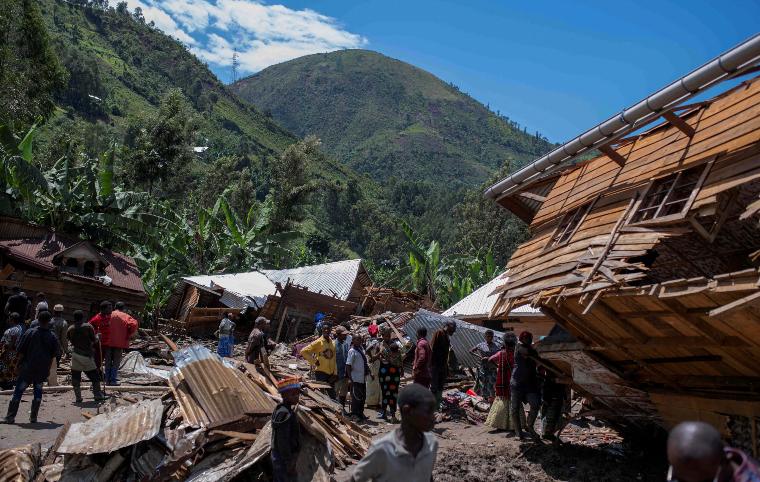 Congolese civilians gather after the death of their family members following rains that destroyed buildings and forced aid workers to gather mud-clad corpses into piles in the village of Nyamukubi, Kalehe territory in South Kivu province of the Democratic Republic of Congo. REUTERS/Stringer/File Photo