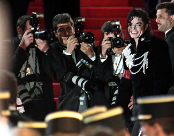 FILE PHOTO: Photographers surround U.S. superstar Michael Jackson (2nd R) who pauses on the red-carpeted stairs of the festival palace as he arrives for the midnight screening of his new movie short "Ghosts"  at the 50th Cannes Film Festival, May 8. The film, shown out of competition, is directed by Stan-Winston.