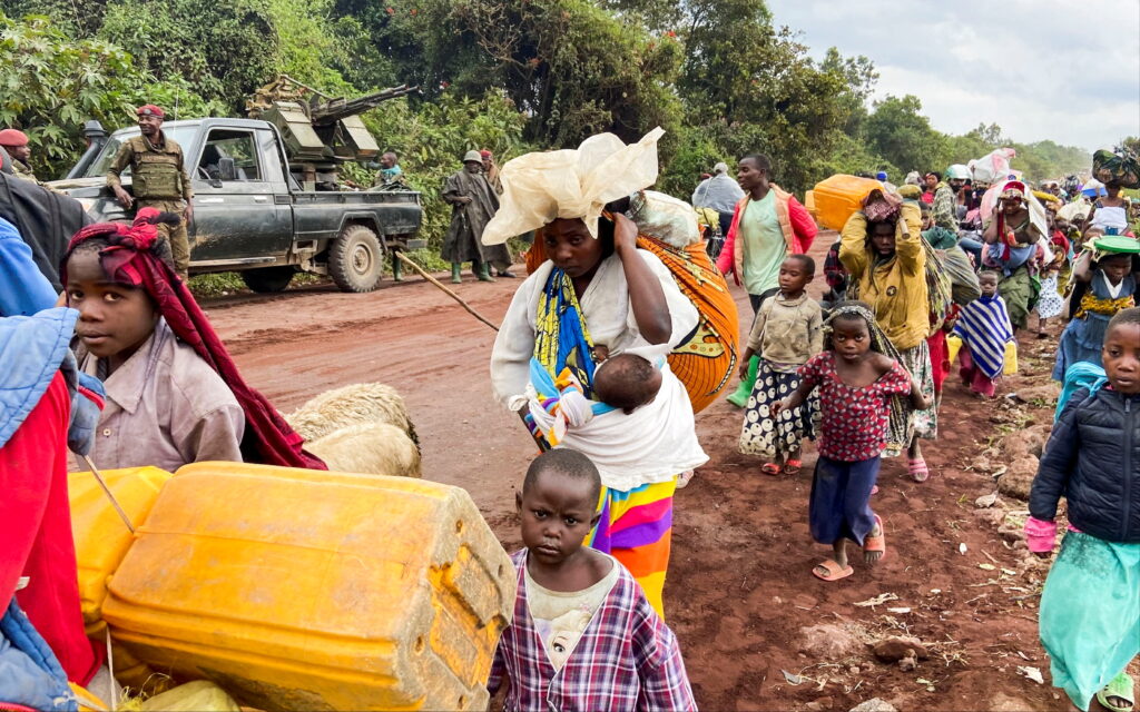 Congolese civilians carry their belongings as they flee near the Congolese border with Rwanda after fightings broke out in Kibumba, outside Goma in the North Kivu province of the Democratic Republic of Congo. REUTERS/Djaffar Sabiti