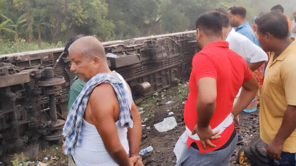 People stand next to a damaged coach, after trains collided in Balasore, India June 3, 2023, in this screen grab obtained from a social media video. Nantu Samui/via REUTERS