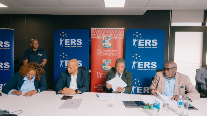 ERS Commissioner General and UNESWA Vice Chancellor Professor Justice M. Thwala exchange signed copies of the Memorandum of Understanding formalising a partnership to deliver specialised AI training for ERS employees through the UNESWA AI Academy. | Photo: ERS